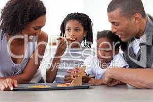 Happy afro-american family eating homemade biscuits