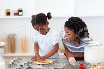 Jolly siblings cooking biscuits