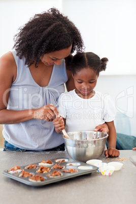 Adorable little girl preparing biscuits with her mother
