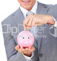 businessman saving money in a piggybank