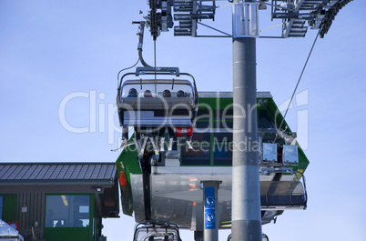 skiing people in ski lift