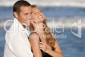 Man and Woman Couple Laughing In Romantic Embrace On Beach