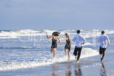 Four Young People, Two Couples, Having Fun On A Beach