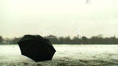 Snow falling on a black umbrella 1