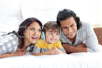 Happy parents listening to music with their son