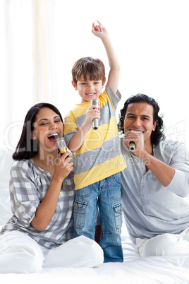 Lively young family singing with microphones