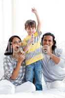 Lively young family singing with microphones