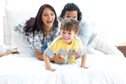 Jolly parents playing with their little boy