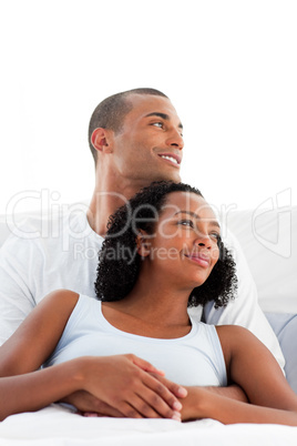 Afro-american lovers hugging on their bed