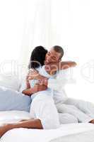 Romantic couple hugging on their bed