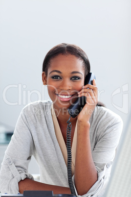 Charming Afro-american businesswoman talking on a phone