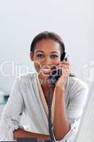 Charming Afro-american businesswoman talking on a phone