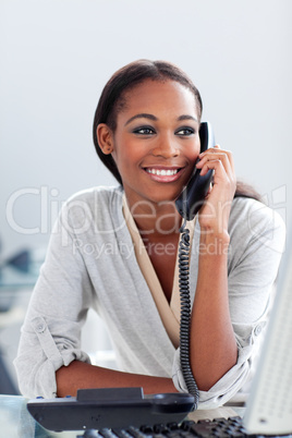 Bright Afro-american businesswoman talking on a phone