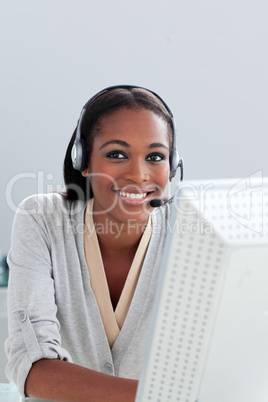 Delighted Afro-american businesswoman using headset