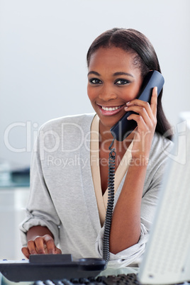 Assertive ethnic businesswoman on phone looking at the camera