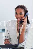 Assertive ethnic businesswoman on phone looking at the camera