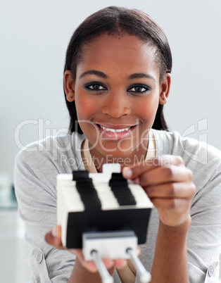 Charming ethnic businesswoman holding a business card holder