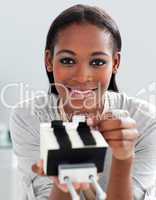 Charming ethnic businesswoman holding a business card holder