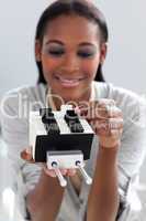 Ethnic businesswoman consulting a business card holder