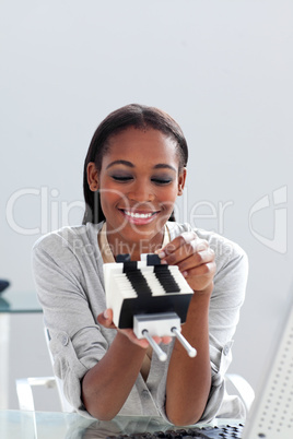 Afro-american businesswoman holding a business card holder