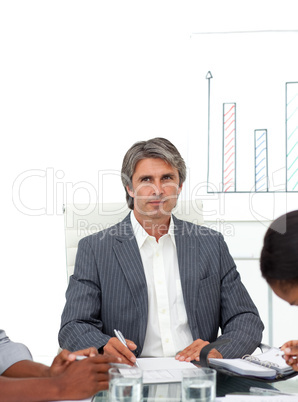 Charismatic mature businessman in a meeting