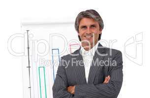 Smiling mature businessman in front of a board