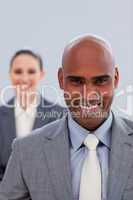 Focus on an attractive ethnic businessman smiling
