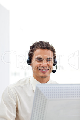 Smiling businessman working at a computer