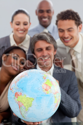 A business group showing ethnic diversity holding a terretrial g