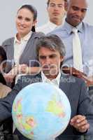 Multi-ethnic business people around a terrestrial globe