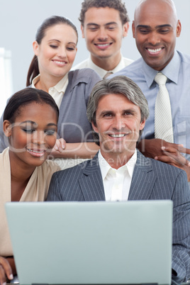 Positive International business people using a laptop