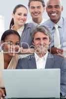 A diverse business team working at a laptop