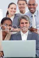 A business group showing ethnic diversity working at a laptop
