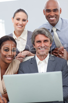 Confident Multi-ethnic business team working at a laptop