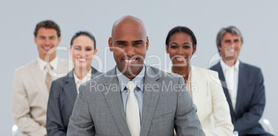 Charismatic Ethnic businessman with his team smiling