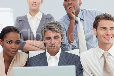 Serious Multi-ethnic business people using a laptop