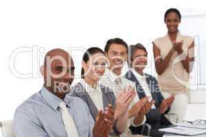 Multi-ethnic business people applauding after a presentation