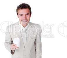 Smiling businessman holding a drinking cup