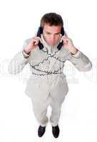 Bored businessman tangle up in phone wires