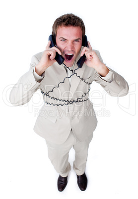Angry businessman tangle up in phone wires