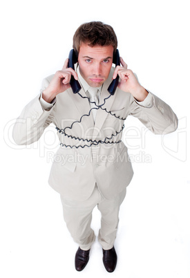 Tired businessman tangle up in phone wires
