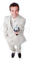 Assertive young businessman holding a service bell