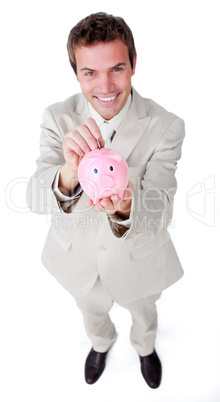 Charismatic businessman saving money in a piggybank