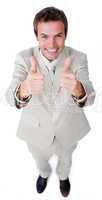 Victorious businessman with thumbs up