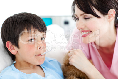 nurse taking little boy's temperature
