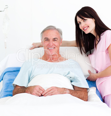 nurse fixing a senior patient's