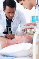 Multi-ethnic Doctors resuscitating a senior patient