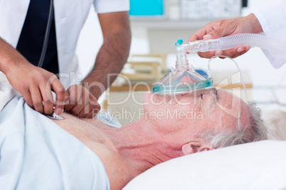 Doctors resuscitating a senior patient