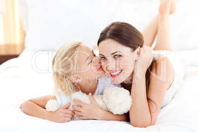 Cute little girl kissing her mother