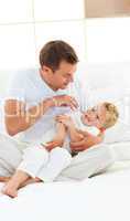 Animated dad and his little boy playing on a bed